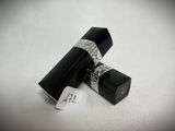 a black tube with a white tag on top of it