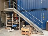 un escalier métallique menant au sommet d'un conteneur bleu