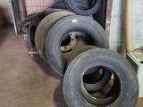 many tires that are stacked up in a room