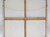 an old window frame with a rope hanging from it ' s side