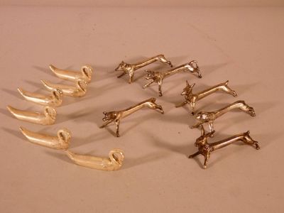 several pieces of silverware sitting on top of a white surface