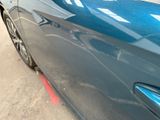 a blue car parked on the side of the street