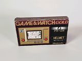 a game and watch gold box with a clock on it