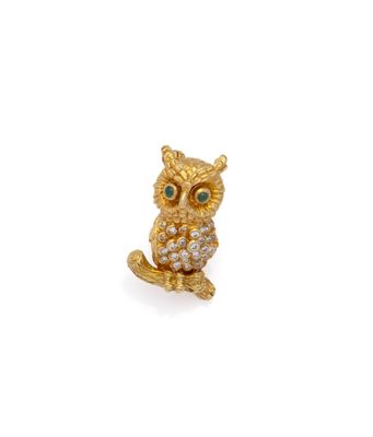 an image of a gold owl broochle with green eyes