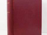 a red book sitting on top of a white table