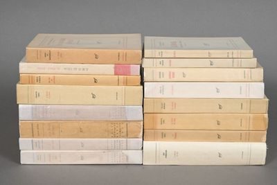 several books stacked on top of each other on a gray surface