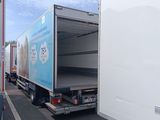 a truck that is parked in the street with its door open