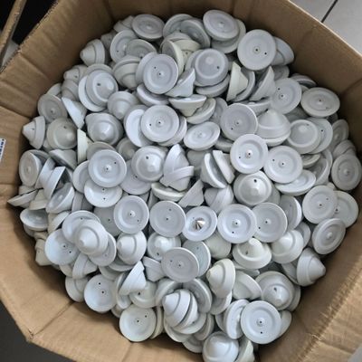 a box full of white buttons sitting on a table