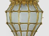 a gold hanging light with a crown on it