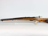 a rifle with a wooden barrel on a white background