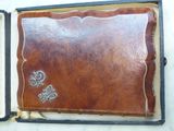 a brown leather case with a silver clasp on it