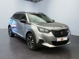 the silver suv is parked in a showroom with a checkered ceiling