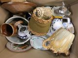 a cardboard box filled with many different types of pottery