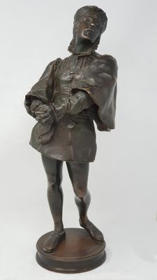 bronze statue of a man with a hat on a pedestal