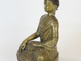statue of a person sitting on a lotus flower in a meditation position