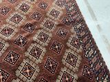 an image of a brown and black rug with a pattern on it