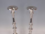 pair of silver plated candlesticks on stand on grey background