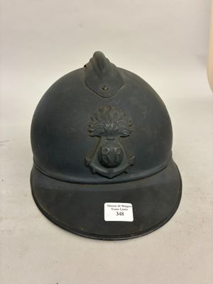 an old black helmet with a crest on the front