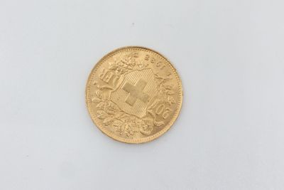 a close up of a gold coin on a white surface