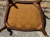 an image of a wooden chair sitting on top of a stone floor