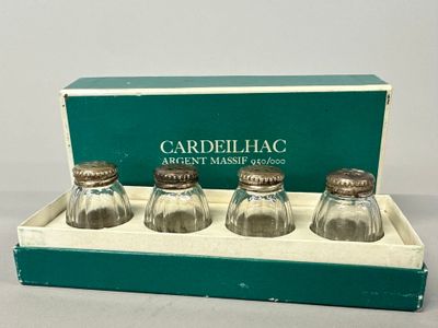 three glass salt and pepper shakers in a box on a table