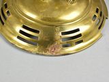 a gold colored lamp that is sitting on a table