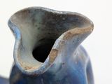 a blue vase that is sitting on a table