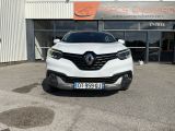 the front view of a white car parked in front of a building