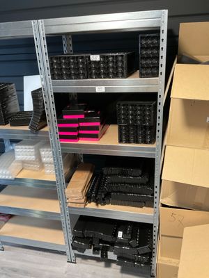 many boxes and bins on the shelves in the store
