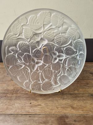 a glass plate with flowers on it sitting on a table