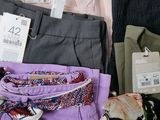 a lot of clothes that are sitting on a table