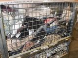 a metal cage filled with assorted items inside of a building