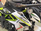 a close up of a motorcycle parked on the street