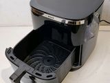 a black and gray air fryer sitting on a counter