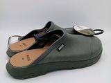 a close up of a pair of green clogs on a white background