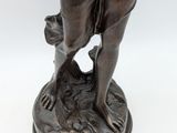 an antique bronze statue of a woman holding a baby
