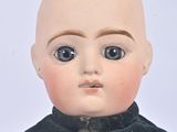 a close up of a doll with a bald head