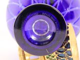 a close up of a purple glass bottle with a gold ring on it