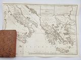 an old map and a leather book on a table