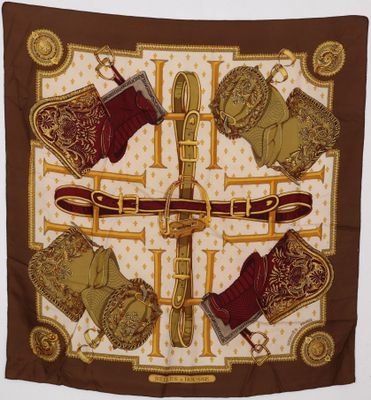 a close up of a brown and gold scarf with boots on it
