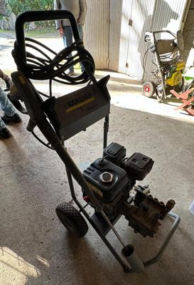 a man standing next to a machine in a garage