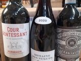 three bottles of wine that are sitting on a table