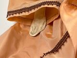 a person holding a piece of cloth with a zipper on it