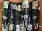 many bottles of wine in a box on the table