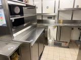 a kitchen with stainless steel cabinets and a microwave