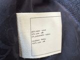 a label on a black jacket with a red and white stripe