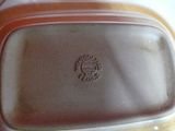 a close up of a plastic container with a brown lid