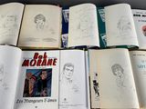 a lot of books that are sitting on a table