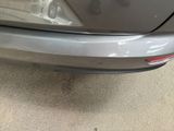 a close up of a car ' s tail light and bumper