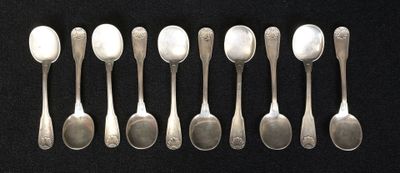 six spoons are lined up in a row on a black surface